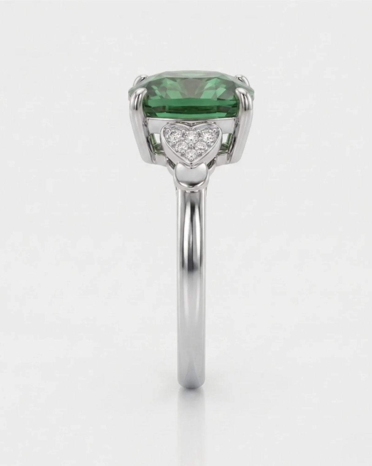 Green tourmaline engagement ring with heart-shaped diamond shoulders in polished platinum | SARATTI