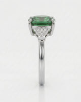 Green tourmaline engagement ring with heart-shaped diamond shoulders in polished platinum | SARATTI