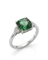 Green tourmaline ring with cushion-cut center stone and heart diamond accents in polished platinum | SARATTI