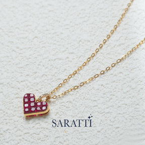 The Yellow Gold Alma Rosa Ruby Heart Necklace against white backdrop | Saratti Fine Jewelry 