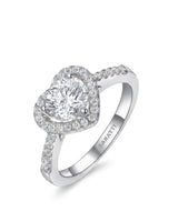 Heart-shaped moissanite engagement ring with halo accents and pavé shoulders in 18K white gold | SARATTI