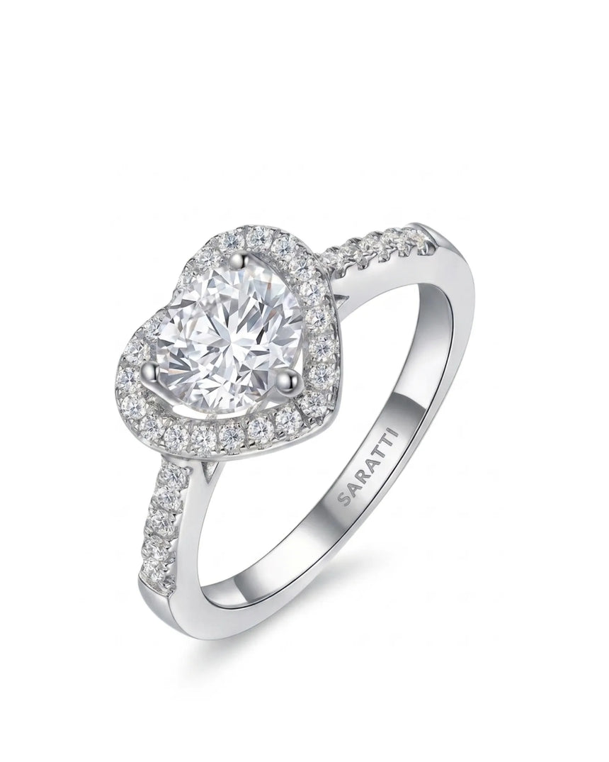 Heart-shaped moissanite engagement ring with halo accents and pavé shoulders in polished platinum | SARATTI