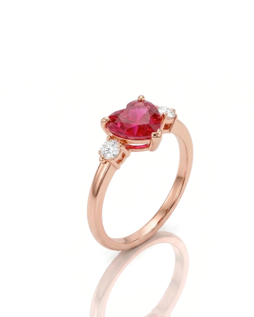 Heart ruby and diamond three-stone ring with round accents in 18K Rose Gold | SARATTI