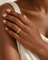 Hot Cross diamond-encrusted wedding band in 18K yellow gold worn on model hand | SARATTI