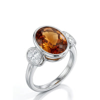 SOLENNE – Imperial Topaz Three-Stone Bezel Setting