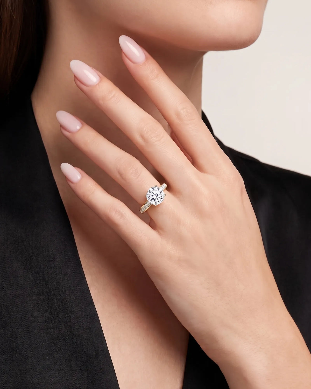 Layla round engagement ring worn on hand with diamond-set band in 18K yellow gold | SARATTI