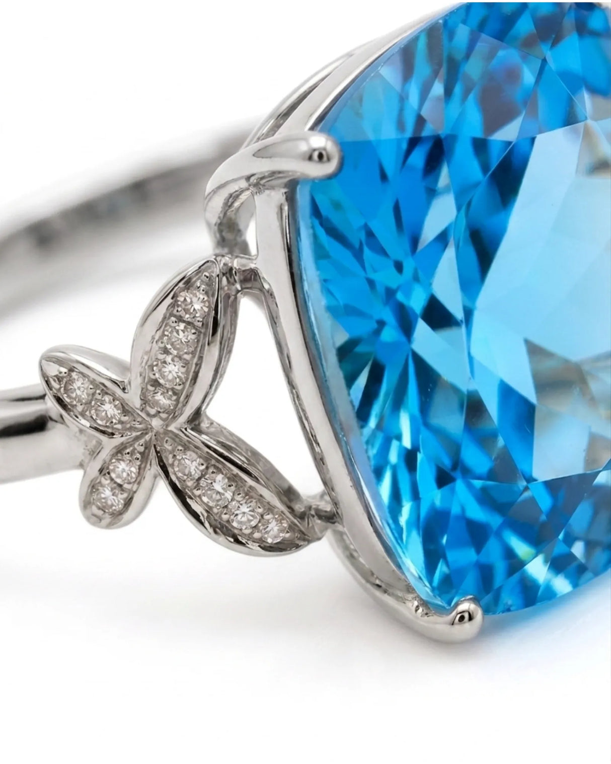 Luxury Swiss Blue topaz statement ring with sculpted diamond shoulders in polished platinum | SARATTI