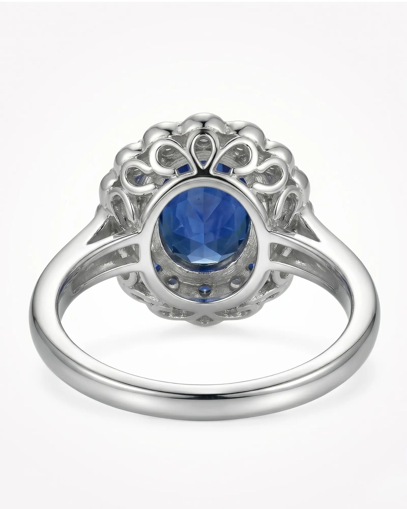 Luxury blue sapphire ring with layered diamond and sapphire halo in 18K white gold | SARATTI