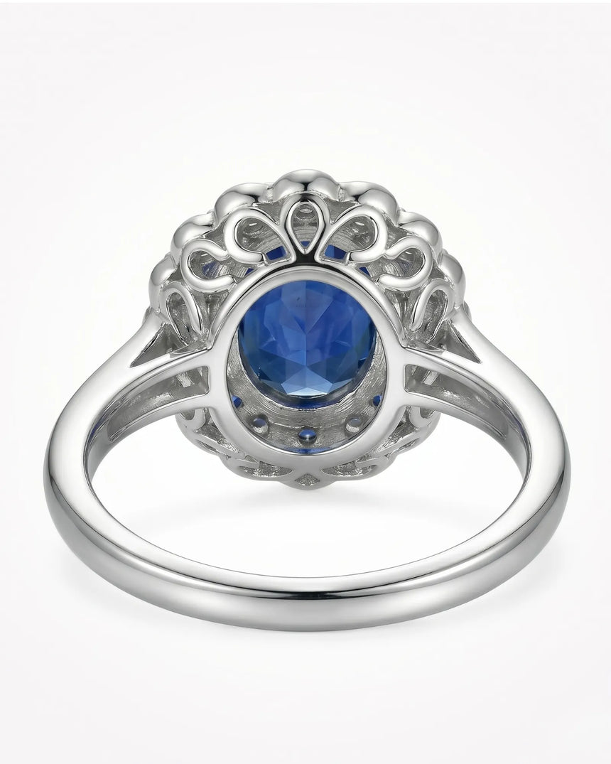 Luxury blue sapphire ring with layered diamond and sapphire halo in 18K white gold | SARATTI