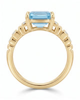 Luxury emerald cut aquamarine ring with round diamonds and warm yellow gold structure | SARATTI