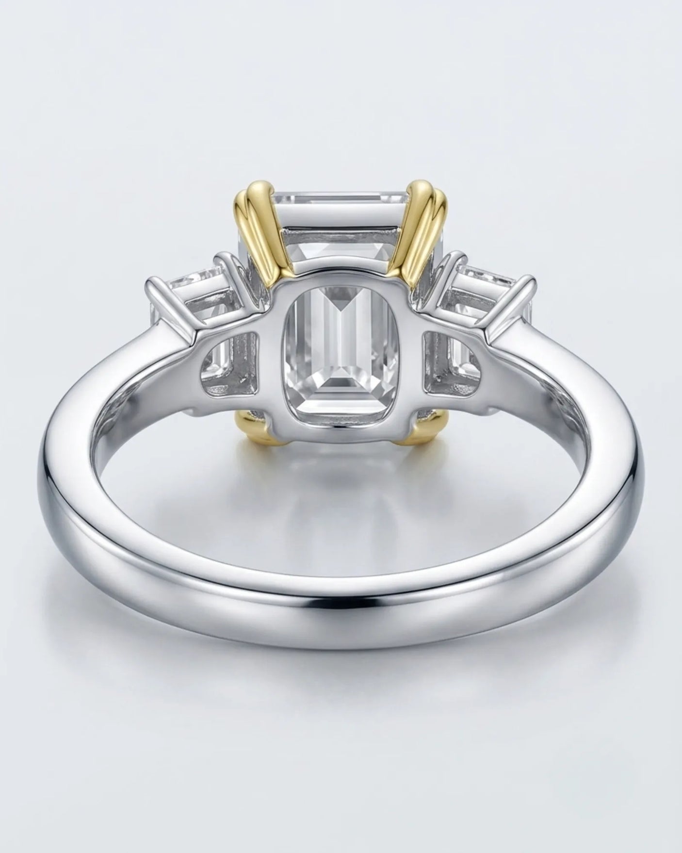 Luxury emerald cut moissanite ring with side stones and refined two tone gold setting - SARATTI
