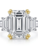 Luxury emerald cut moissanite ring with side stones and refined two tone gold setting | SARATTI