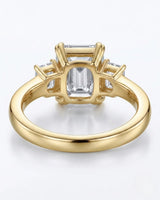 Luxury emerald cut moissanite ring with side stones and rich yellow gold finish - SARATTI