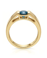 Luxury men’s ring with tension-set blue diamond and substantial 18K yellow gold profile | SARATTI