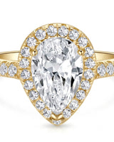 Luxury moissanite engagement ring featuring a pear center and luminous halo in yellow gold | SARATTI