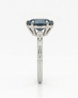 Luxury oval blue moissanite ring with accent stones and polished white gold finish | SARATTI
