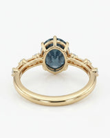 Luxury oval blue moissanite ring with accent stones and rich yellow gold finish - SARATTI
