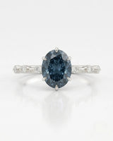 Luxury oval blue moissanite ring with accent stones and timeless platinum finish | SARATTI