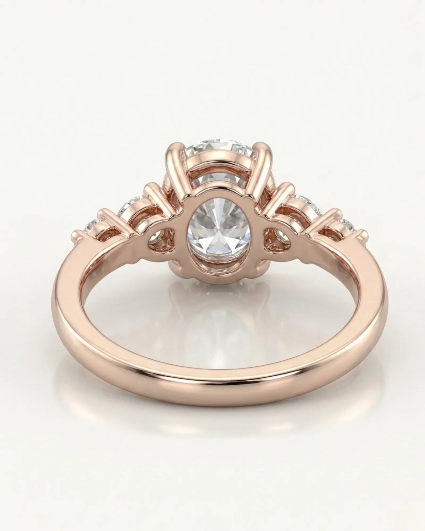 Luxury oval diamond ring with graduated side stones and bespoke 18K rose gold craftsmanship | SARATTI