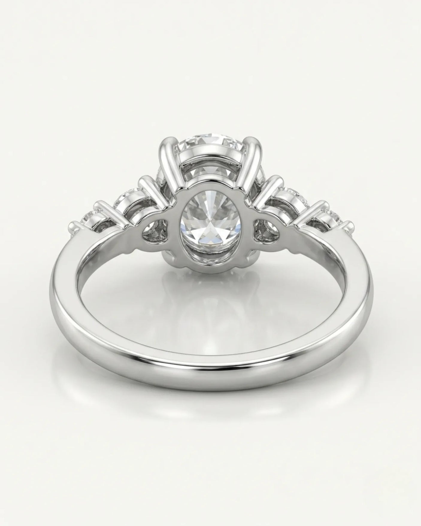 Luxury oval diamond ring with graduated side stones and bespoke 18K white gold craftsmanship - SARATTI
