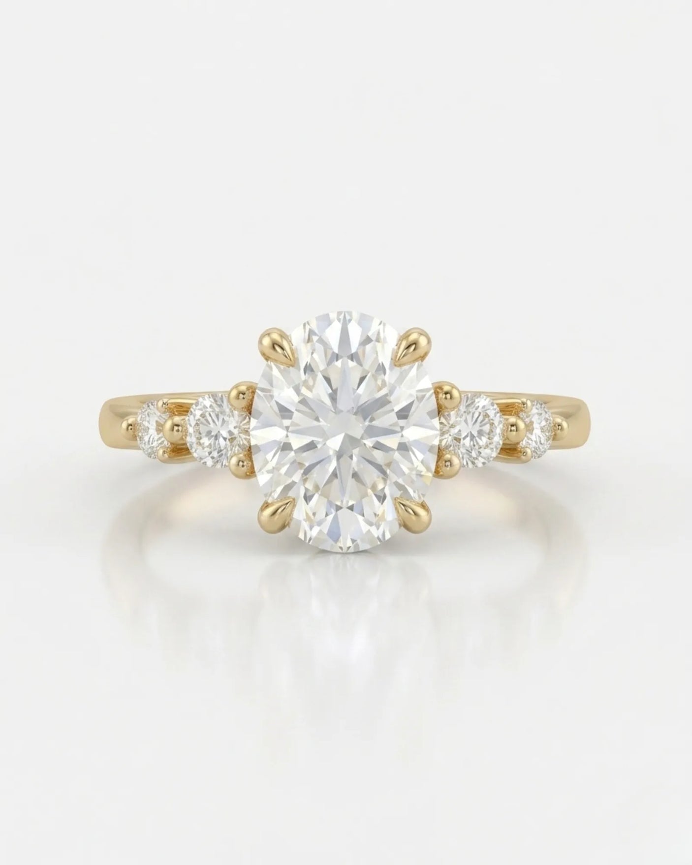 Luxury oval diamond ring with graduated side stones and bespoke 18K yellow gold craftsmanship - SARATTI