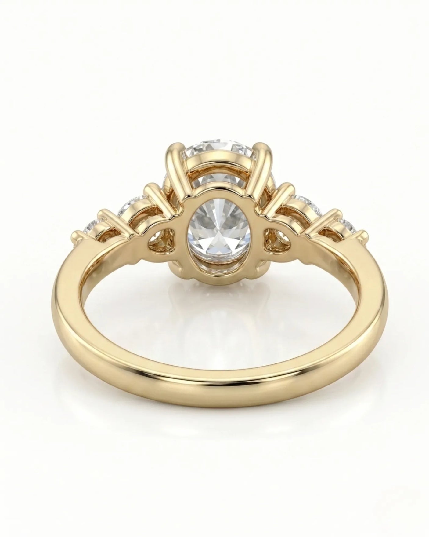 Luxury oval diamond ring with graduated side stones and bespoke 18K yellow gold craftsmanship | SARATTI
