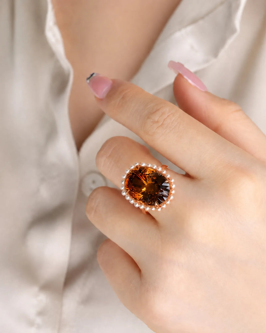 Luxury oval gemstone ring pairing natural Imperial Topaz, pearls, and premium 18K rose gold | SARATTI