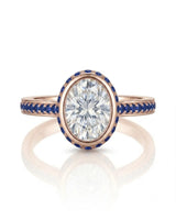 Luxury oval moissanite and natural sapphire ring with protective bezel in 18K rose gold | SARATTI