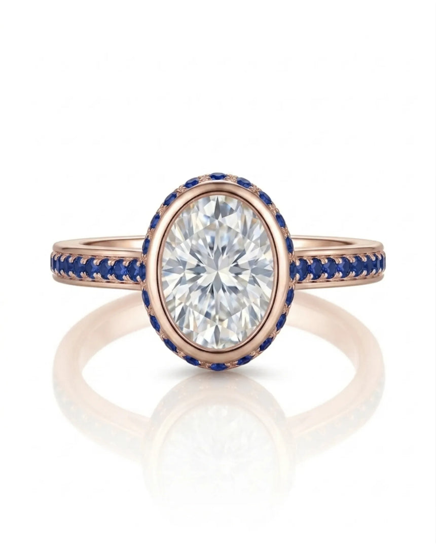 Luxury oval moissanite and natural sapphire ring with protective bezel in 18K rose gold | SARATTI