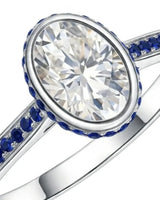 Luxury oval moissanite and natural sapphire ring with protective bezel in 18K white gold - SARATTI