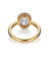 Luxury oval moissanite and natural sapphire ring with protective bezel in 18K yellow gold - SARATTI