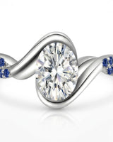 Luxury oval moissanite and natural sapphire ring with sculptural white gold ribbon setting | SARATTI.