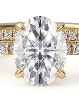 Luxury oval moissanite bridal set with matching pavé bands and rich 18K yellow gold craftsmanship | SARATTI