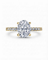 Luxury oval moissanite pavé engagement ring with polished yellow gold architecture | SARATTI