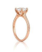 Luxury oval moissanite ring with brilliant pavé shoulders and warm rose gold setting | SARATTI