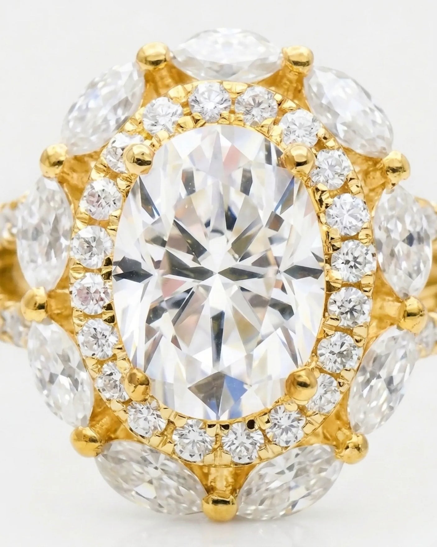 Luxury oval moissanite ring with floral halo and pavé split shank in yellow gold | SARATTI