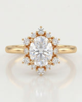 Luxury oval moissanite ring with floral halo and rich yellow gold setting | SARATTI