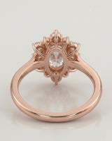 Luxury oval moissanite ring with floral halo and warm rose gold setting | SARATTI