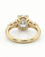 Luxury oval moissanite ring with graduated side stones and rich yellow gold setting - SARATTI