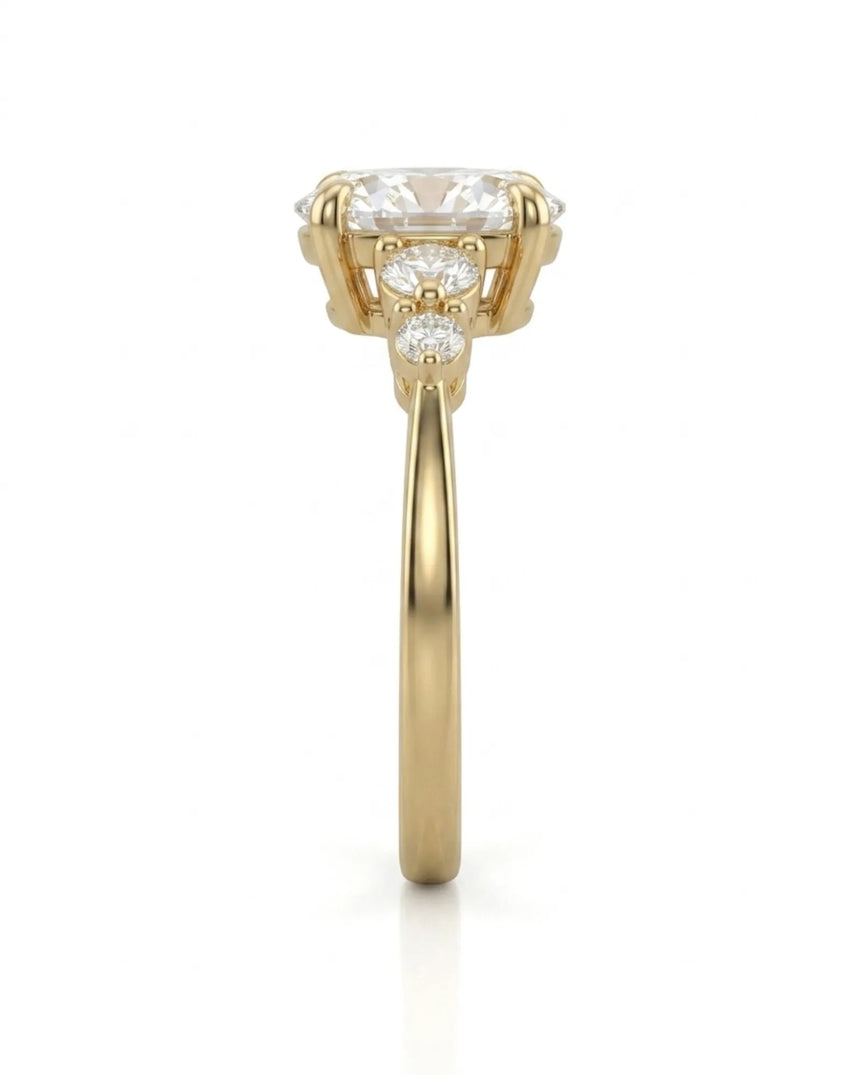 Luxury oval moissanite ring with graduated side stones and rich yellow gold setting | SARATTI