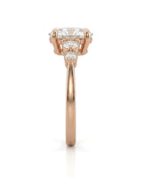 Luxury oval moissanite ring with graduated side stones and warm rose gold setting -- SARATTI