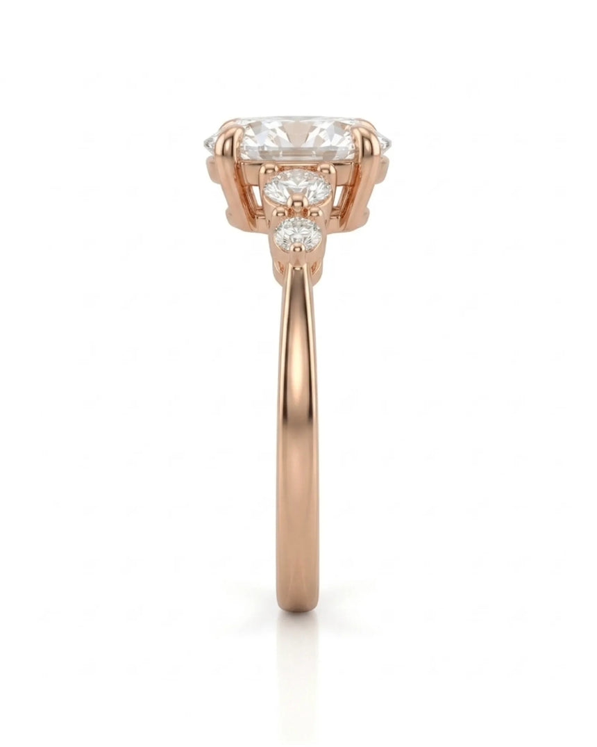 Luxury oval moissanite ring with graduated side stones and warm rose gold setting -- SARATTI