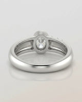 Luxury oval moissanite ring with sculptural wave band and clean white gold setting | SARATTI