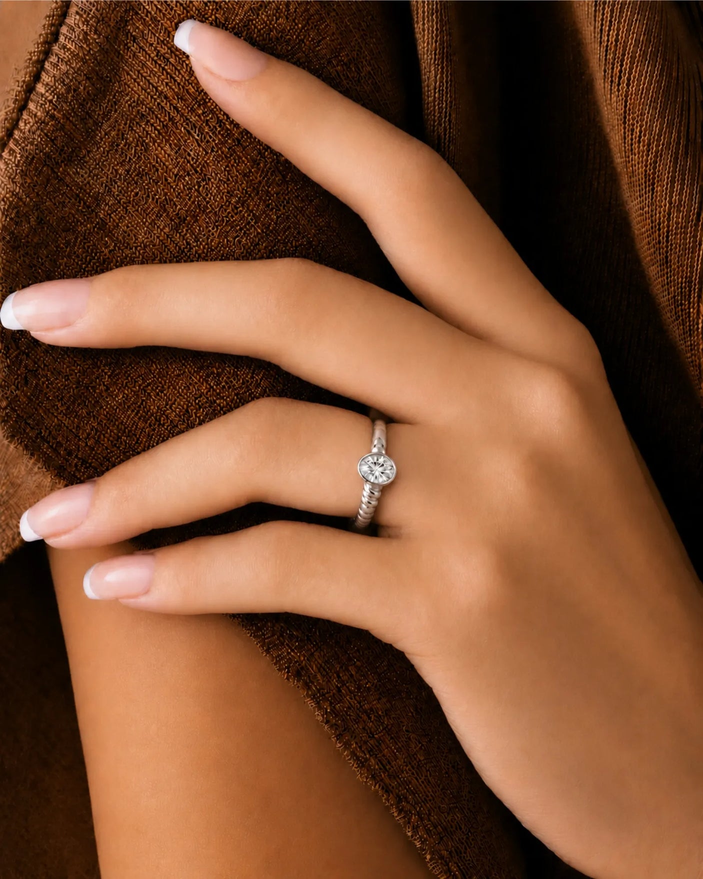 Luxury oval moissanite ring with sculptural wave band and timeless platinum setting | SARATTI