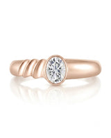 Luxury oval moissanite ring with sculptural wave band and warm rose gold setting | SARATTI