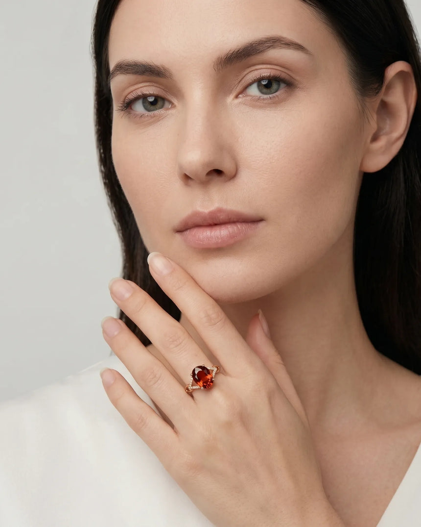 Luxury oval orange garnet ring with diamond accents in 18K rose gold | SARATTI