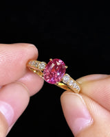 Luxury oval purple sapphire ring with graduated diamond band detailing in 18K yellow gold | SARATTI