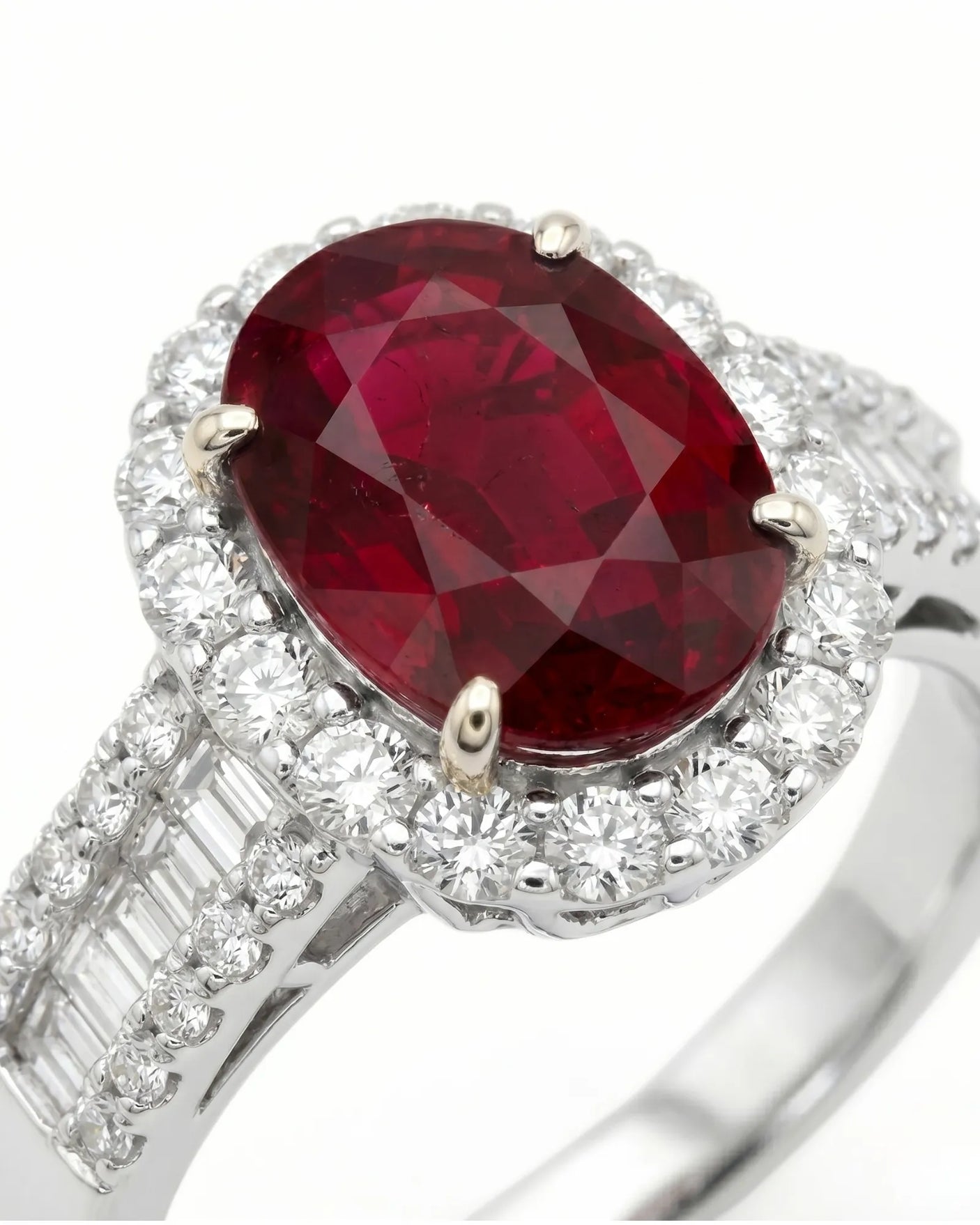 Luxury oval ruby halo ring with diamond shoulders in refined white gold | SARATTI