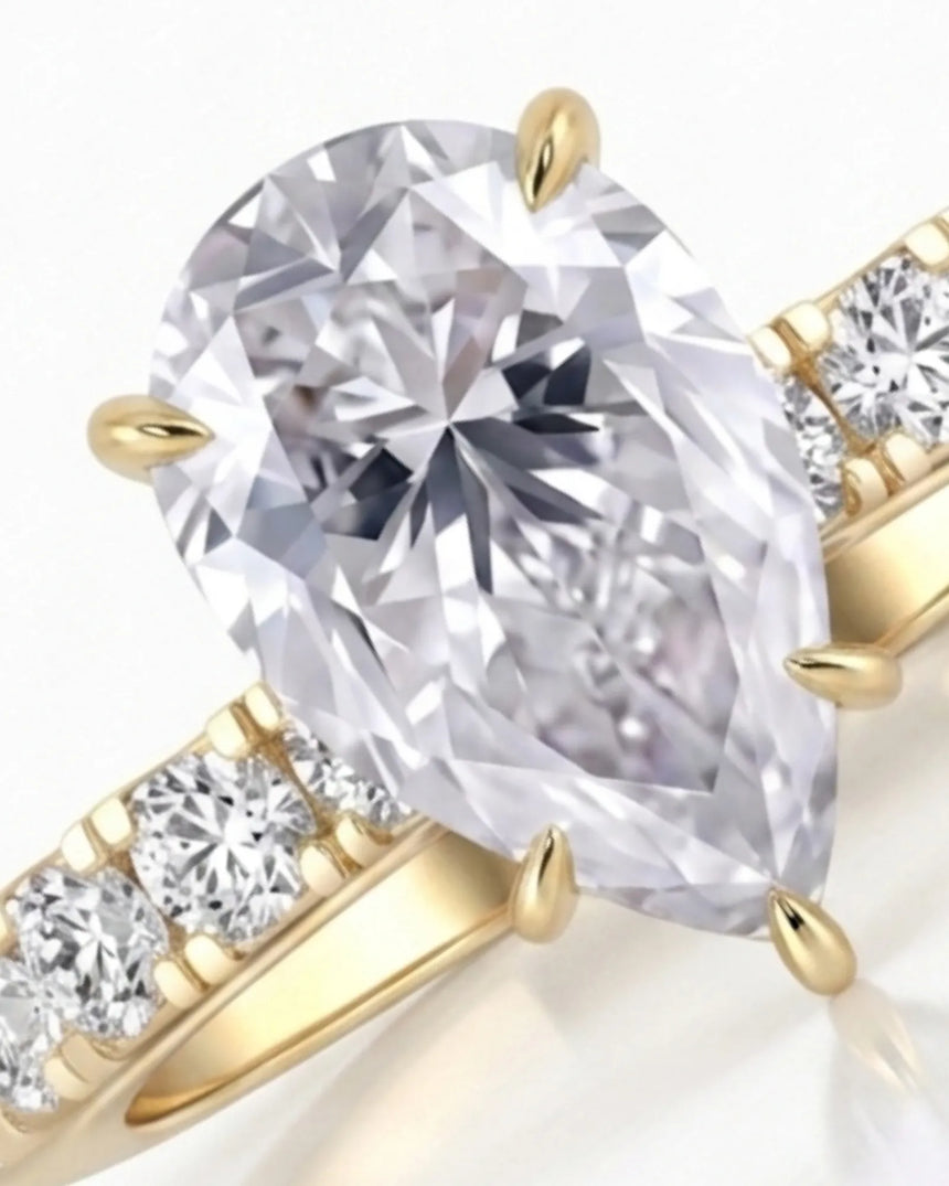 Luxury pear cut moissanite ring with detailed gallery and luminous accents in 18K yellow gold - SARATTI