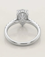 Luxury pear cut moissanite ring with sculptural gallery and luminous shoulder accents in platinum | SARATTI
